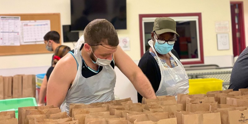 A man filling bags with food