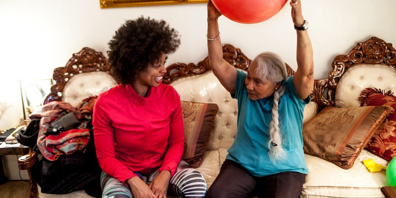 A young woman and an older woman sitting on a couch together