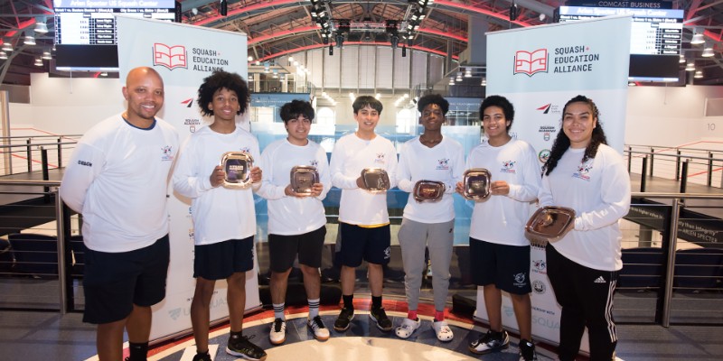 A group of teenagers holding plaques