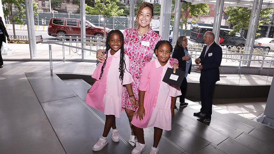 A woman and two children pose for a photo.