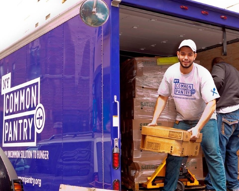 Man in a truck with a box of food.