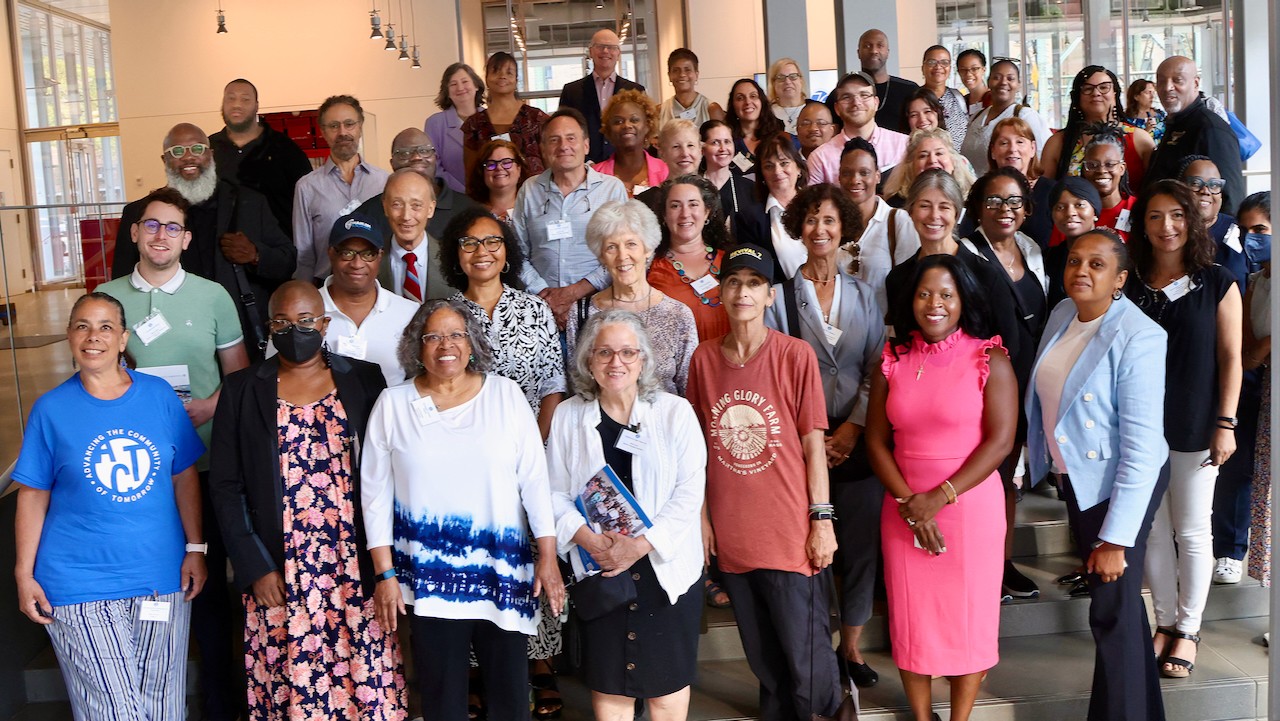 A large group of CCS grantees smile for the camera in the lobby of the Columbia University Forum. Photo by Bruce Gilbert
