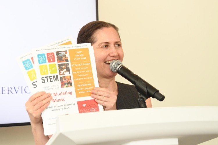 A woman holds up a number of pamphlets