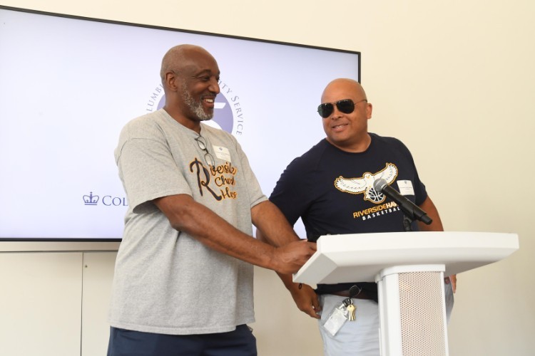 Photo by Eileen Barroso Two men standing at a lectern
