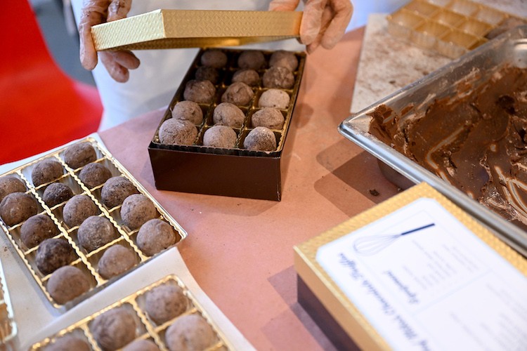 A box of handmade truffles being closed.