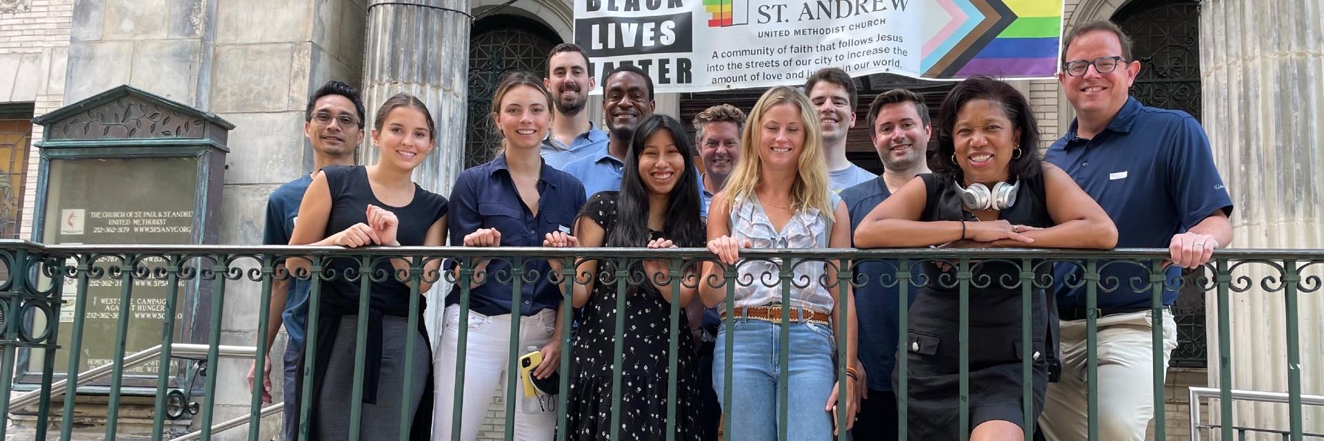 A group of people standing in front of a church