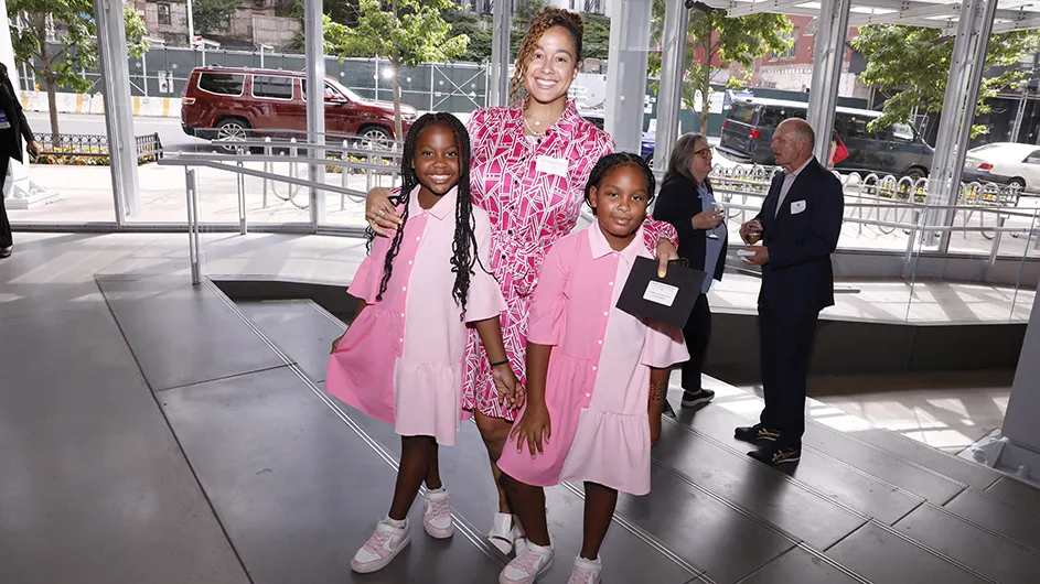 A woman and two children pose for a photo.