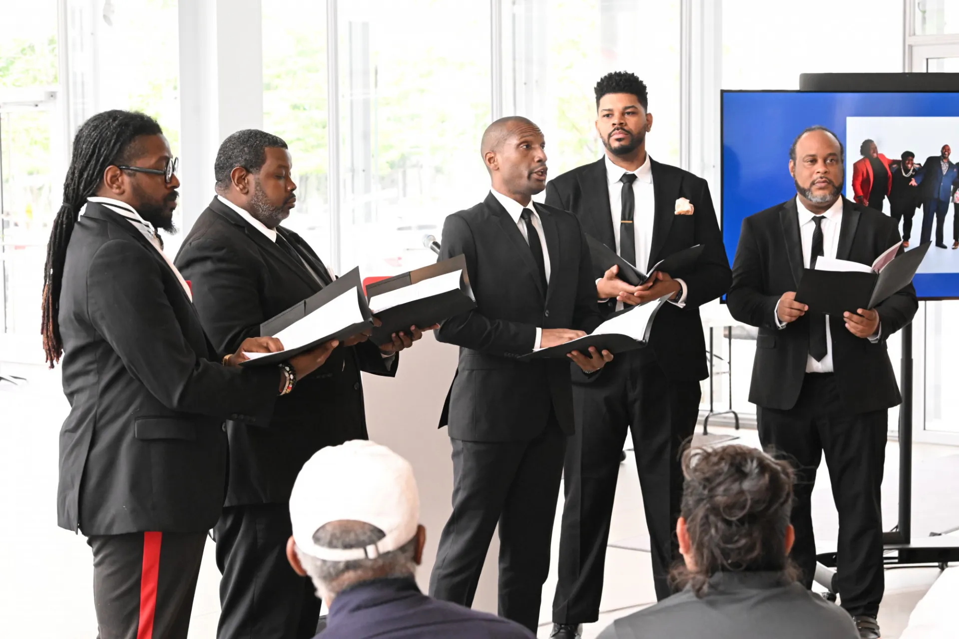 A chorus group is singing to the audience. 