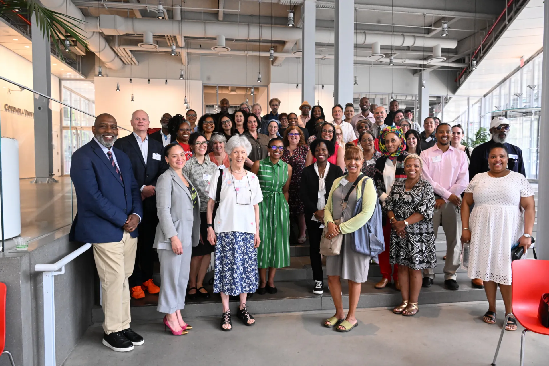 A group of grantees and speakers pose for a photo. 