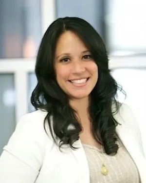A woman with long hair wearing a white jacket