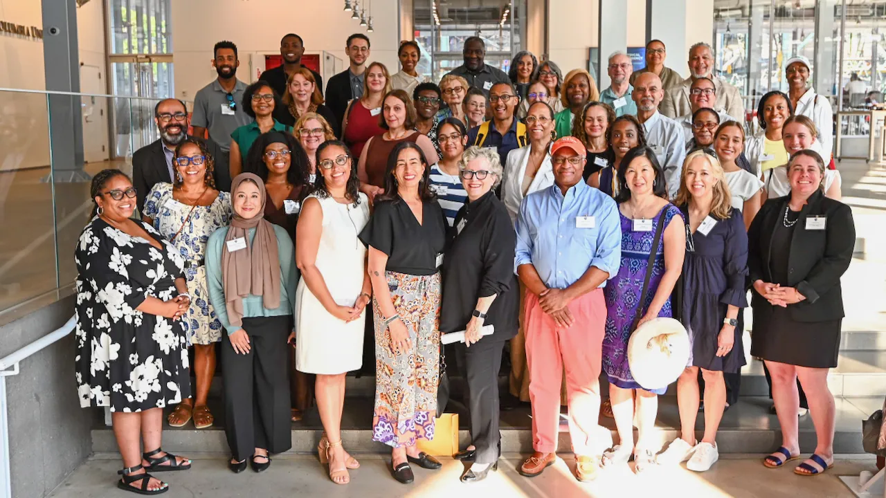 A group of grantees and speakers pose for a photo.