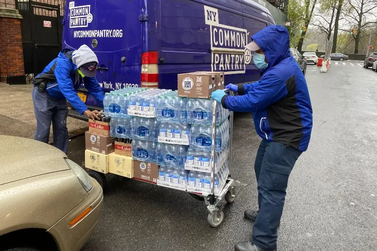 two men and a delivery truck with supplies
