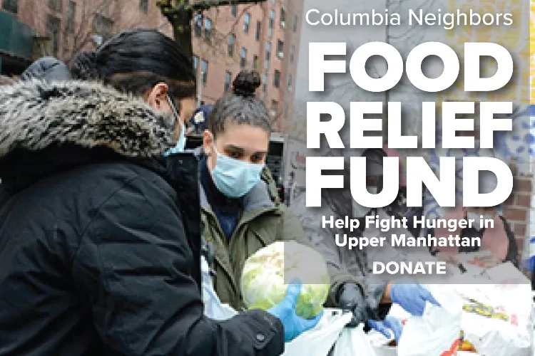 two women in jackets, wearing masks, collecting groceries from food distribution