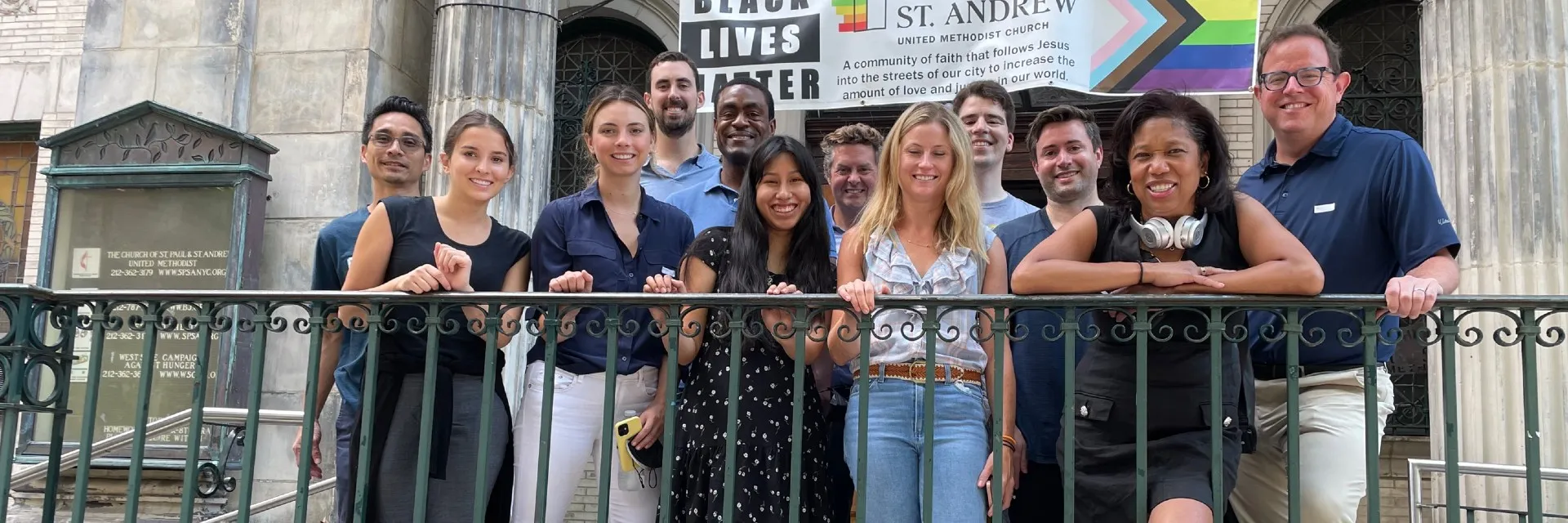 A group of people standing in front of a church