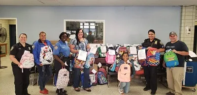 Picture of people holding up backpacks